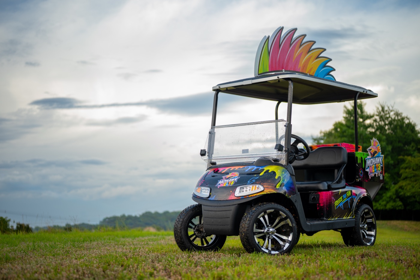 The Mohawk Melts cart with its rainbow crest, parked in the grass