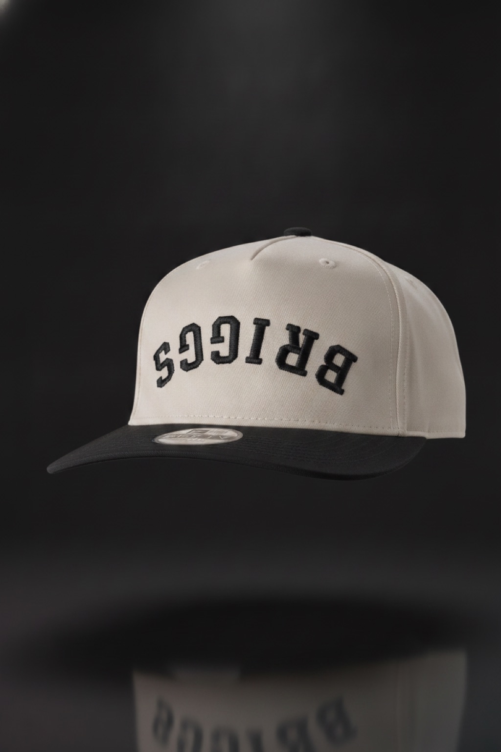 Briggs Snapback — cream hat with upside-down BRIGGS embroidery — $34.95, one size